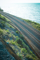 The railroad tracks pass through forest trails, between sea views and cliffs that make it beautiful. Stunning railroad concept.
