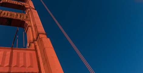 Part of Golden Gate Bridge construction on blue sky background in San Francisco, California, USA