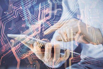 Double exposure of man's hands holding and using a digital device and tech theme hologram drawing. Technology concept.