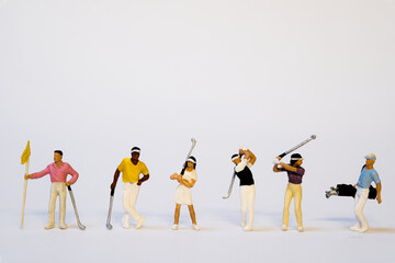 Miniature golfer team - rear view, white background, copy space