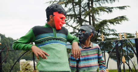 Male young South Asian friends in scary masks in India