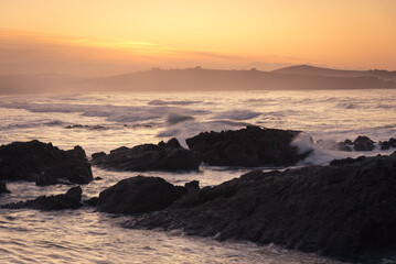 Beautiful seascape at the famous surfing beach of Valdearnas at sunset, Dunas de Liencres Natural Park and Costa Quebrada, Cantabria, Spain