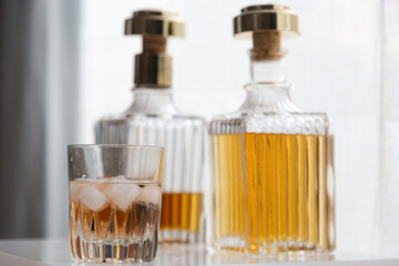 Luxury glass bottles with different alcoholic spirits inside, copy space photo