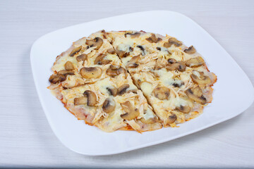 Traditional pizza with mushrooms, with cheese, pomodoro pasta on checkered napkin