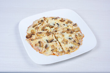 Traditional pizza with mushrooms, with cheese, pomodoro pasta on checkered napkin