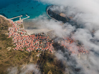 Obraz premium small seaside village in the mist, aerial photo