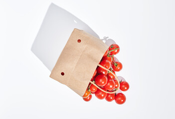 fresh tomatoes in paper bag on white background