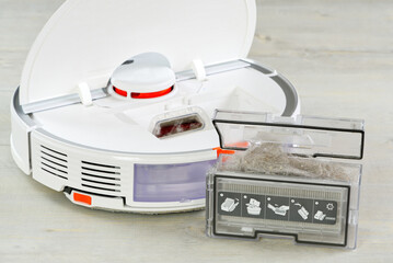 robot vacuum cleaner water tank removed and the filter lid is opened to clean. Smart cleaning and washing technology. advanced robot to vacuum then mop. close up