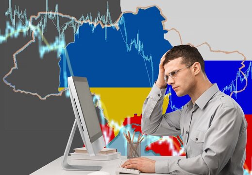 A failed investor emotion. Man sad and see in front of laptop with Ukraine and Russia flag.