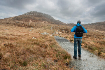 Male tourist walking towards Diamond hill, Connemara National Park, Ireland. Travel and hiking...
