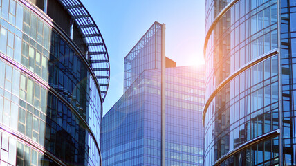 Glass building with transparent facade of the building and blue sky. Structural glass wall...