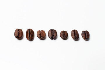 Close-up of few coffee beans isolated on white background.