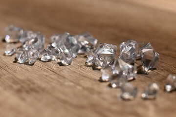 Closeup shot of diamonds on a wooden table