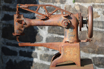 Old rusty sewing machine outdoors