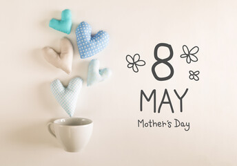 Mother's Daymessage with blue heart cushions coming out of a coffee cup
