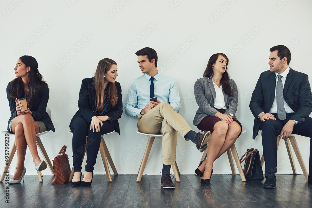 Poster Connecting with the competition. Studio shot of a group of businesspeople talking while waiting in line.