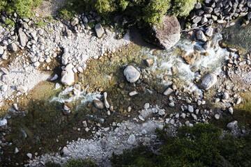 Aerial top view of a beautiful mountain river in summer: natural background of a mountain stream...