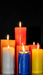 Set of several different size candles lit