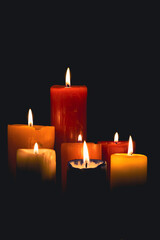 Set of several different size candles lit