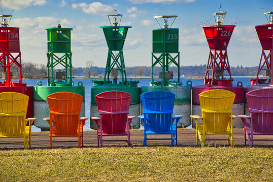 Close-up shot of colorful ocean buoys and chairs on a sunny day