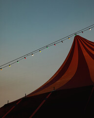 Vertical shot of a circus tent and lights at sunset in Orio, Gipuzkoa, Basque, Spain