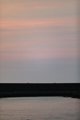 Vertical shot of the Oria river during a scenic cloudy sunset