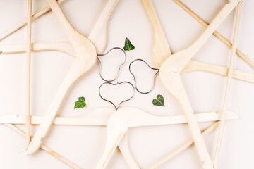 Hangers with plants on white background with copy space.Conscious and environmentally friendly consupmtion in shopping.Zero waste.Shopping,sale,promo, concept.Top view flat lay copy space. - obrazy, fototapety, plakaty