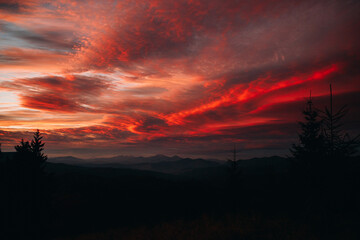 Magical sunset in the mountains. The sky is covered with clouds 