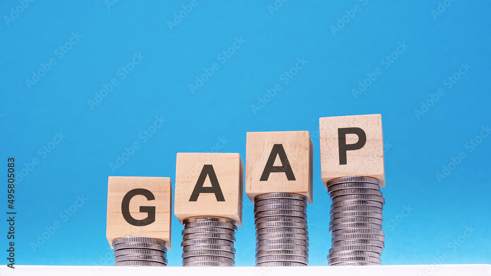 Aufkleber gaap - text on wood cube block stack with coins