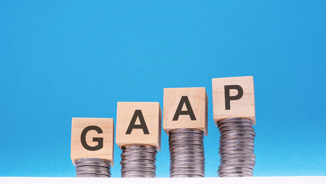 gaap - text on wood cube block stack with coins