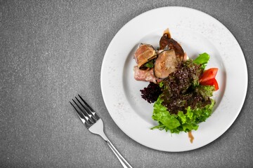 Roast rib steak, fried beef meat on a plate with salad.