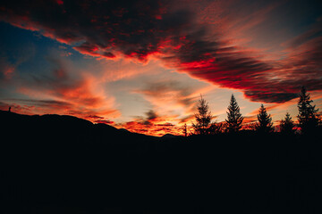 Magical sunset in the mountains. The sky is covered with clouds