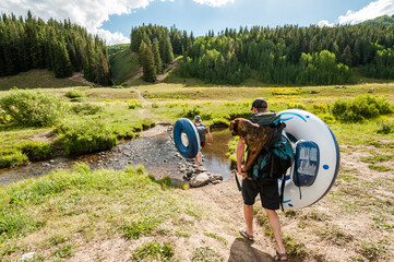 Young couple going for a swim with their dog a lake