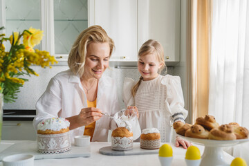 Mom and daughter cook together in the kitchen.