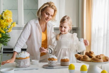 Mom and daughter cook together in the kitchen.