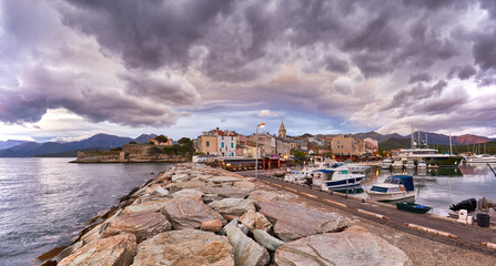 Panorama of beautiful Saint Florent town and harbour in the evening light, Corsica island, France,...