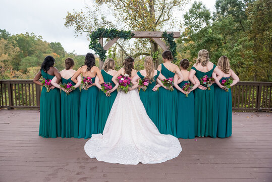 Bride with her bridesmen with intertwined hands