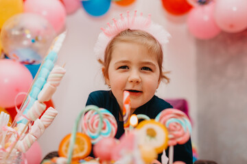  Girl with her birthday cake, happy birthday card,a cute little girl celebrates birthday surrounded by gifts
