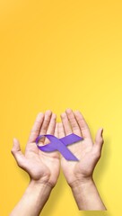 Hands holding purple ribbon on background. International Epilepsy Day. Alzheimer's disease. World Lupus Day and world cancer.