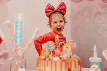  Girl with her birthday cake, happy birthday card,a cute little girl celebrates birthday surrounded...