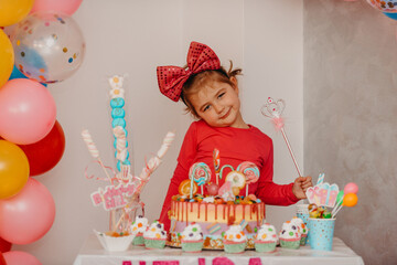 Obraz na płótnie Canvas Girl with her birthday cake, happy birthday card,a cute little girl celebrates birthday surrounded by gifts