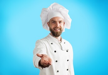Bearded male chef in white uniform. Chef in white uniform, chef hat.