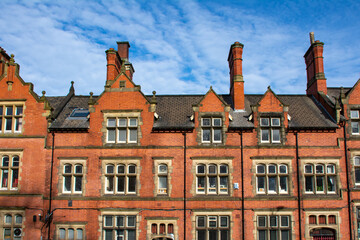 Fototapeta na wymiar The Old Courts, Wigan town center, with blue skys behind. Built in the 1880's this building is grade II listed for its historical importance. Wigan, England.