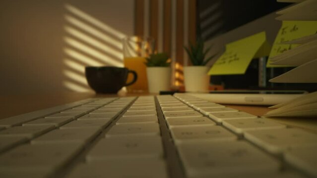 close-up slide shot of empty workspace. macro shot on office desk with keyboard and notes, freelance concept