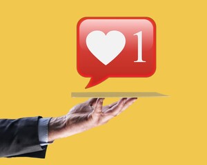 Man hand holding social media like icon with sign to follow subscribe