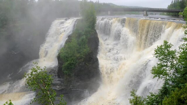 Kakabeka Falls Provincial Park in Thunder Bay in rain and fog with bridge in background
