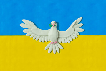 Ukraine flag made by hand with blue and yellow plasticine. Dove of peace. Pray for Ukraine. Stop Ukraine war. Blue and yellow. handmade from plasticine