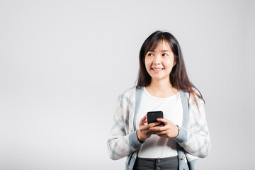 Woman excited read social network feedback on smartphone studio shot isolated white background, young female smiling typing sms message on mobile phone in social media