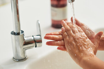Stay healthy by washing your hands. Cropped shot of an unrecognizable woman washing her hands at a...