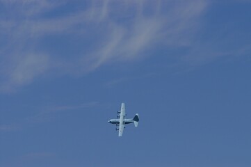 Aircraft flying against the background of autumn blue sky